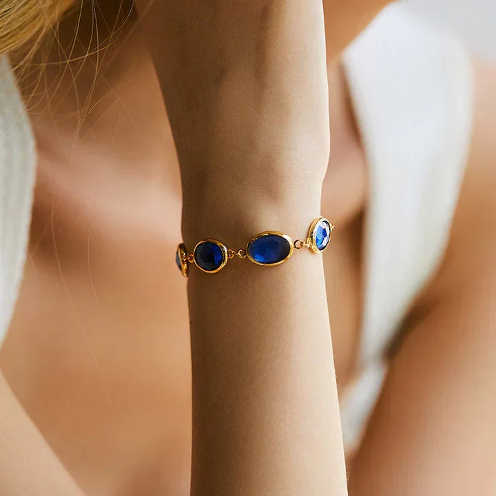Bracciale a catena dorato con zaffiri ovali
