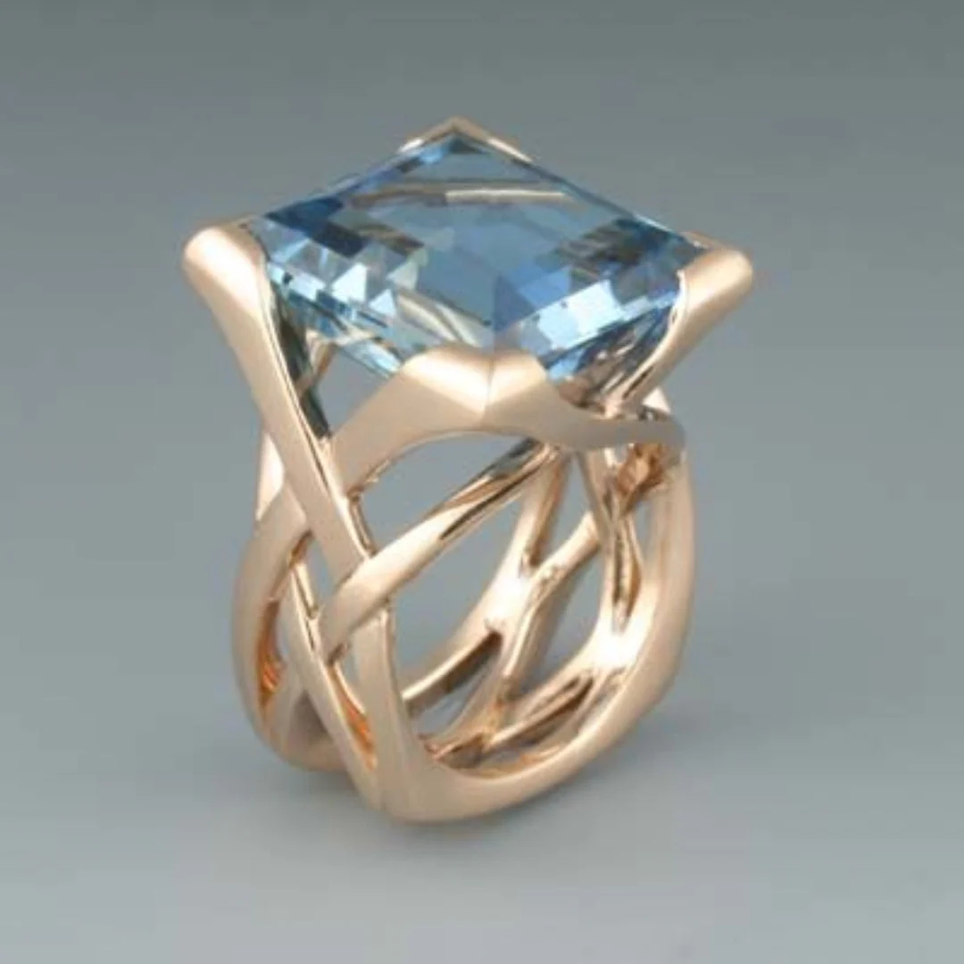 Anello rosa dorato con zirconi blu